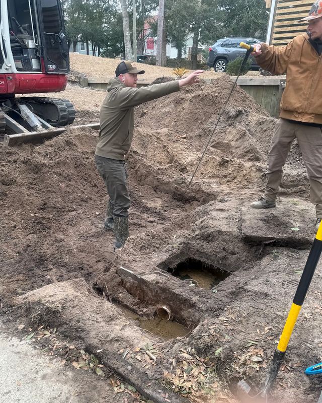Crew working an excavated septic tank